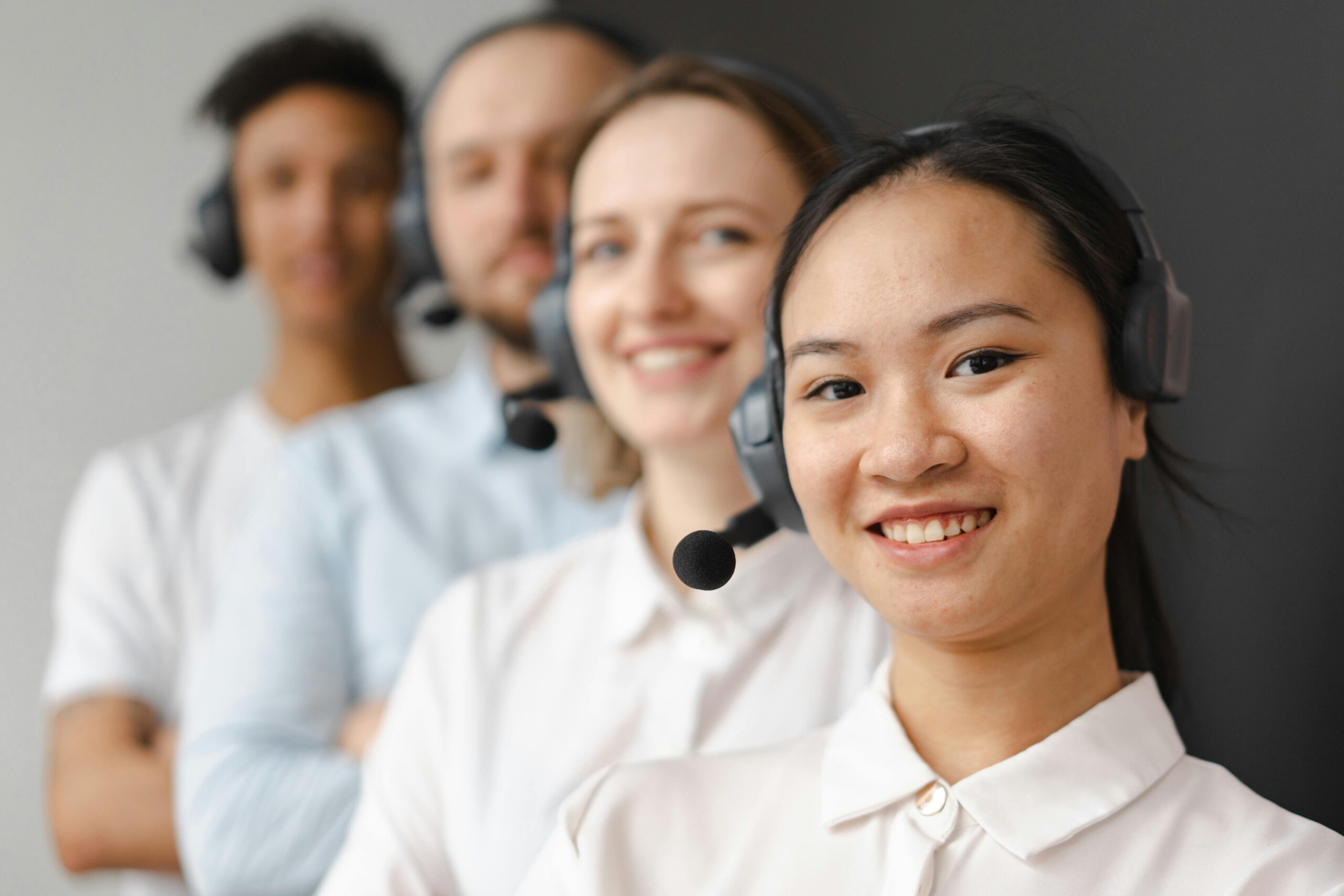 A focused call center professional using a headset at work in an office setting.