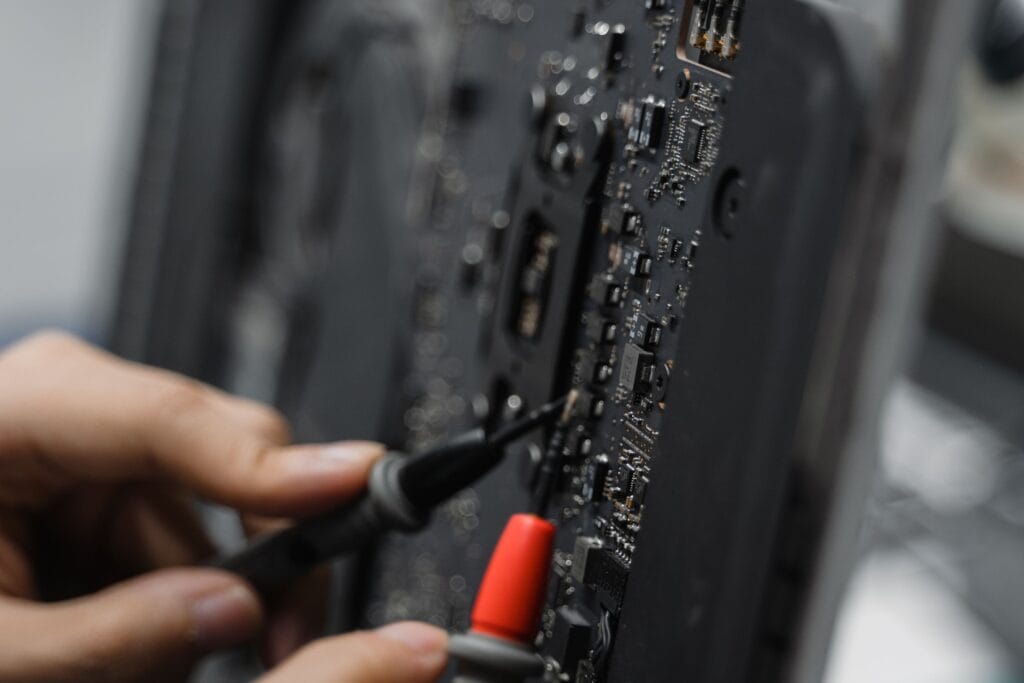 pexels-photo-6755133-6755133 A technician uses tools to repair a circuit board, focusing on microelements.